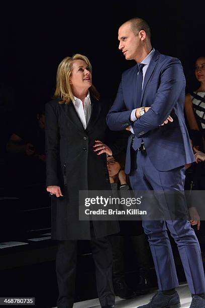 Designer Pamella Roland and photographer Nigel Barker watch rehearsal during the Pamella Roland Show during Mercedes-Benz Fashion Week Fall 2014 at...