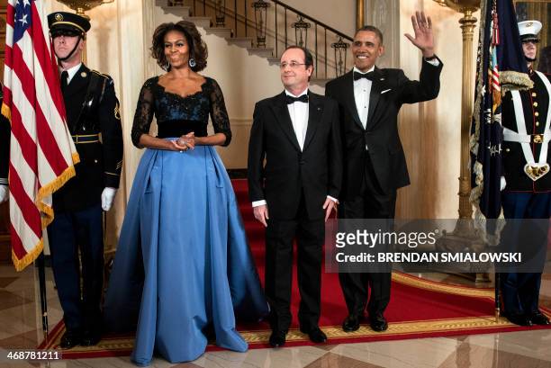 First Lady Michelle Obama , French President Francois Hollande and US President Barack Obama pose in front of the Grand Staircase for an official...