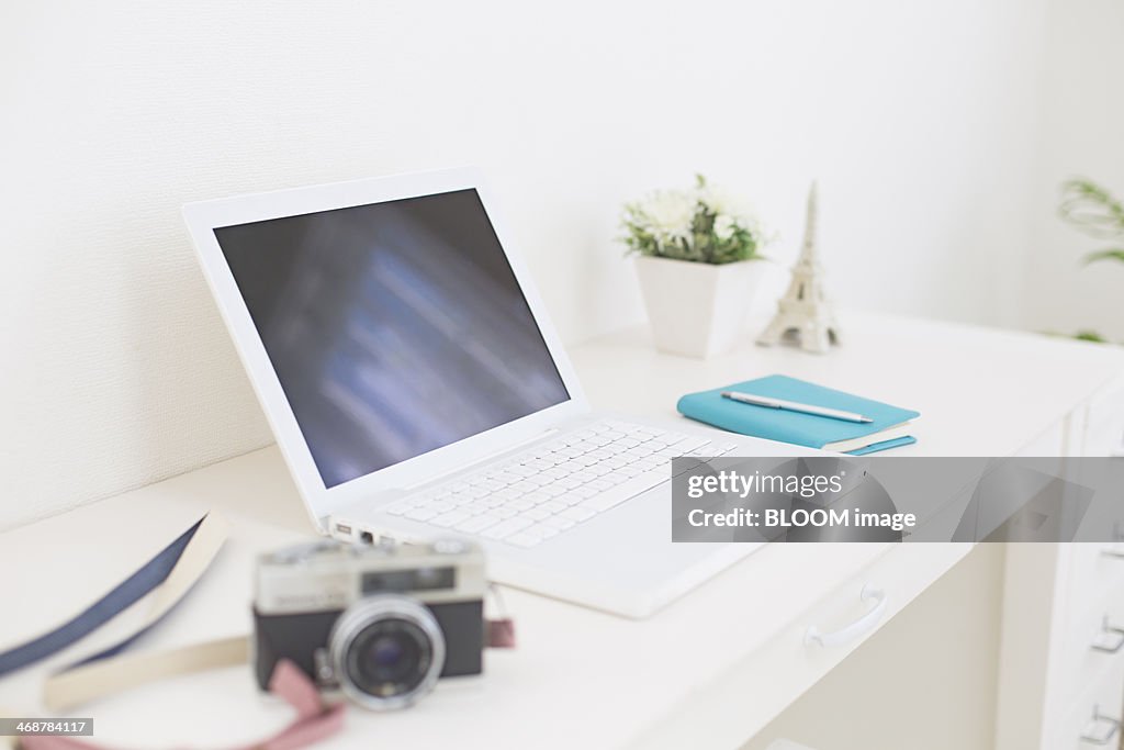 Laptop and vintage camera on desk