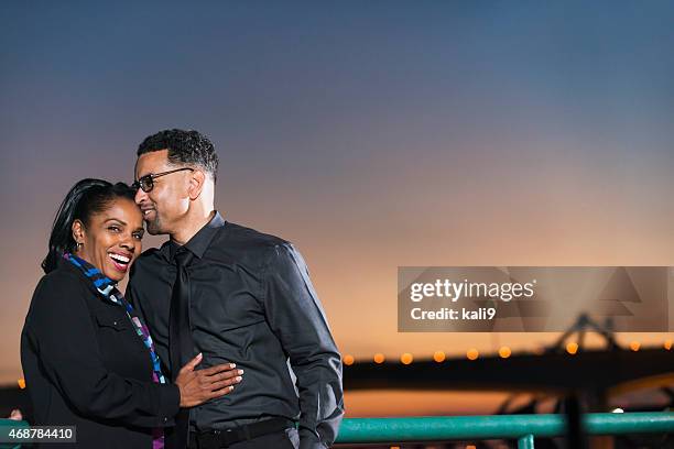 black couple at night, sky and bridge in background - couple dark background stock pictures, royalty-free photos & images