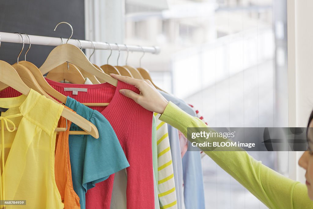 Woman choosing clothes in shop