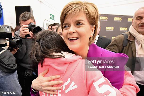 Scotland's First Minister Nicola Sturgeon, hugs a girl following giving a speech setting out the SNP's plans to reduce child poverty at Forestbank...