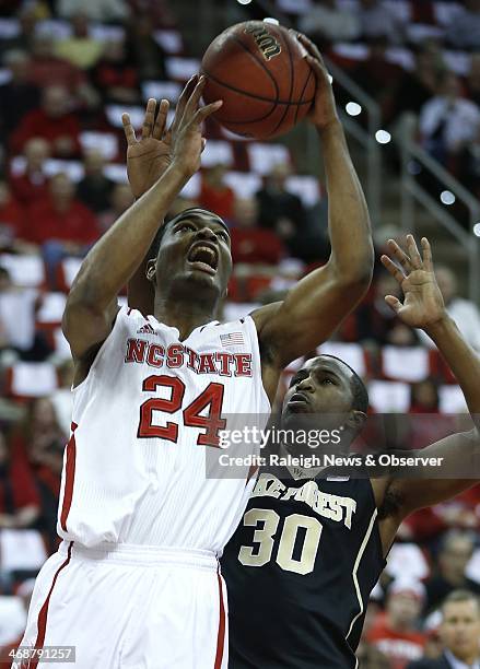 North Carolina State's T.J. Warren shoots as Wake Forest's Travis McKie defends during the first half at PNC Arena in Raleigh, N.C., Tuesday, Feb....