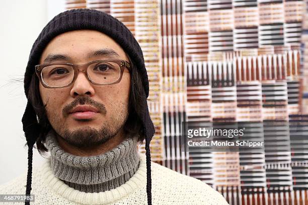 Designer Akiyoshi Mishima poses with his design at the Leather Japan presentation during Mercedes-Benz Fashion Week Fall 2014 on February 11, 2014 in...