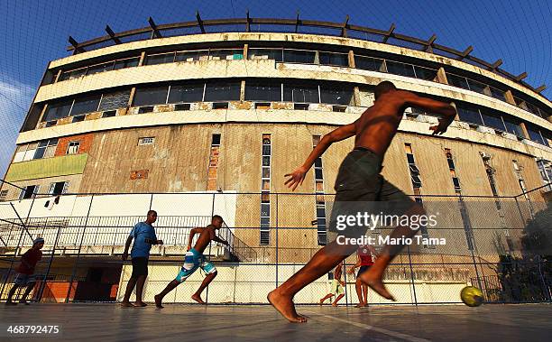 Young residents play soccer in the Cantagalo shantytown community next to neighboring Pavao-Pavaozinho on February 11, 2014 in Rio de Janeiro,...