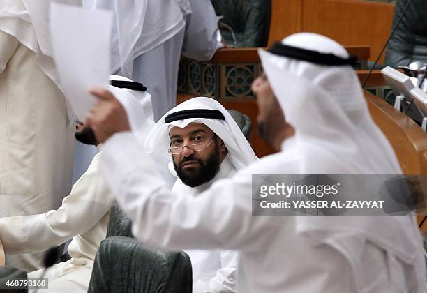 Kuwaiti Oil Minister Ali al-Omair looks on as Shiite MP Yousef al-Zalzalah speaks during a parliament session at the national assembly in Kuwait City...