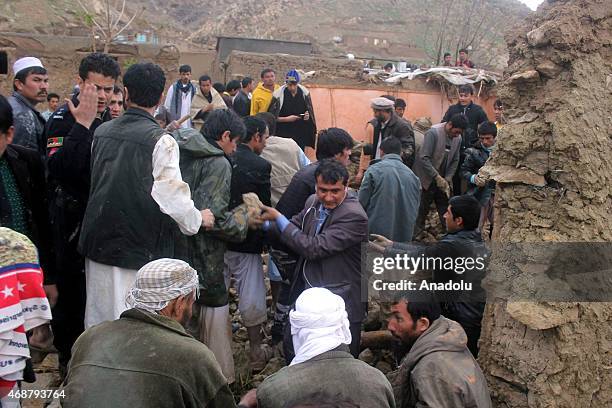People try to rescue others after flood hit Baghlan City in Afghanistan killing six people on April 7, 2015.