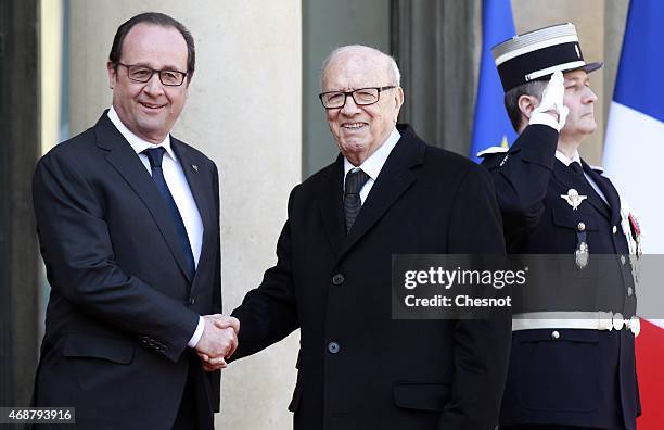 French President Francois Hollande welcomes Tunisian President Beji Caid Essebsi prior a meeting at the Elysee Palace on April 07, 2015 in Paris,...