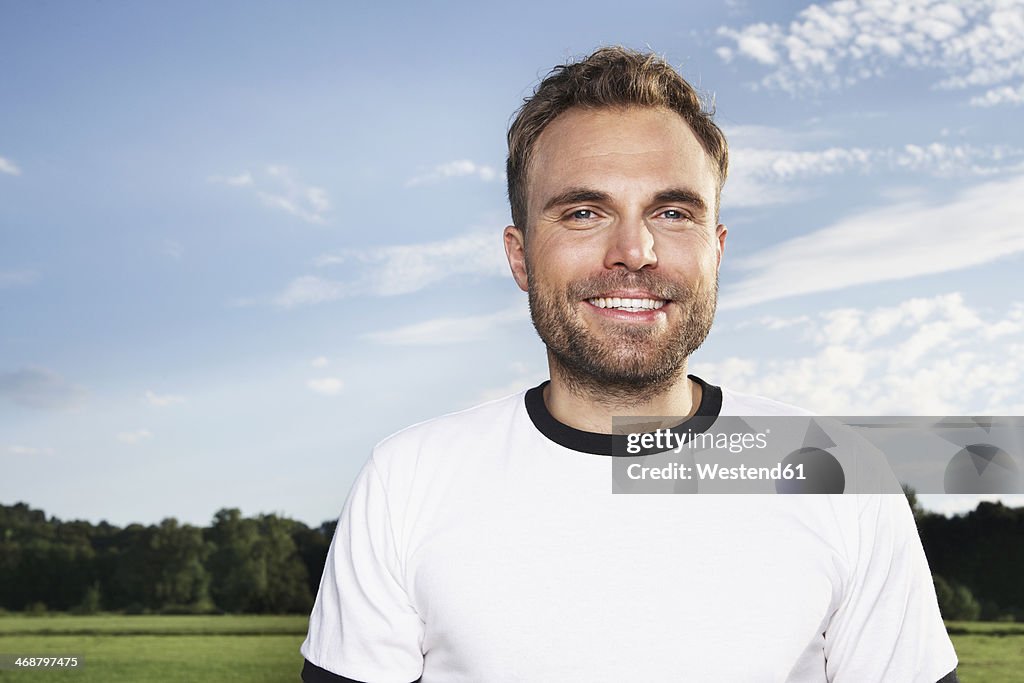 Germany, Cologne , Portrait of young man, wearing football shirt