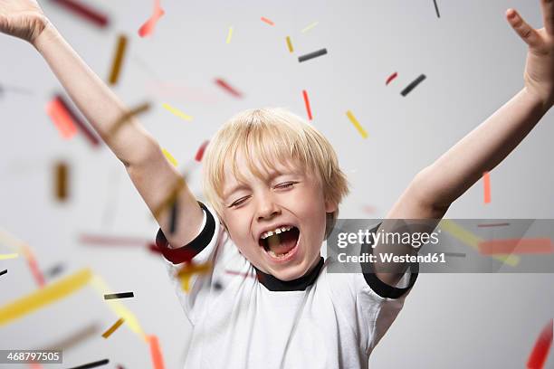 boy in soccer jersey cheering - headshots soccer stock-fotos und bilder