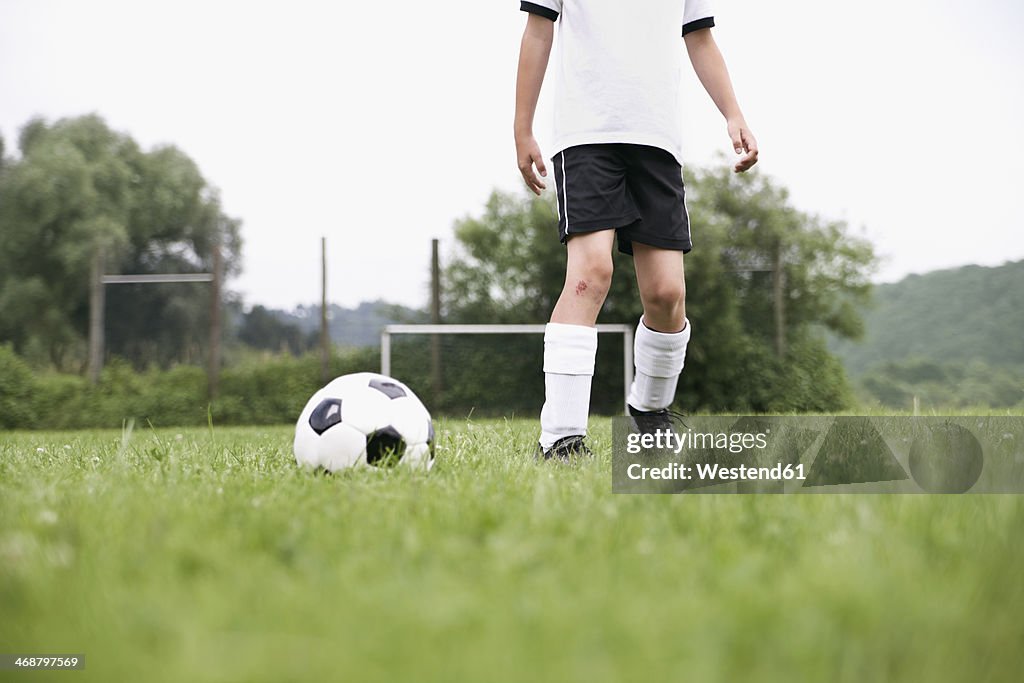 Boy in soccer jersey with ball