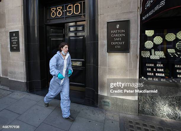 Woman believed to be a police forensics officer emerges from a Hatton Garden safe deposit centre on April 7, 2015 in London, England. Police are...