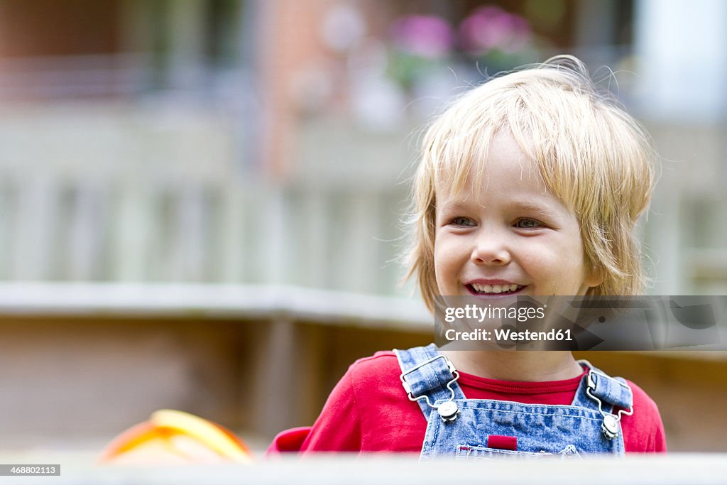 Germany, Schleswig-Holstein, Kiel, portrait of smiling little girl at playground