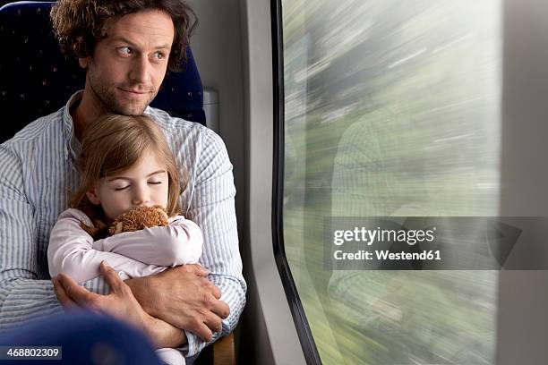 father and daughter in a train - speelgoedtrein stockfoto's en -beelden
