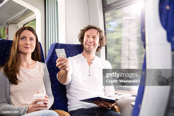 couple in a train - ticket stockfoto's en -beelden