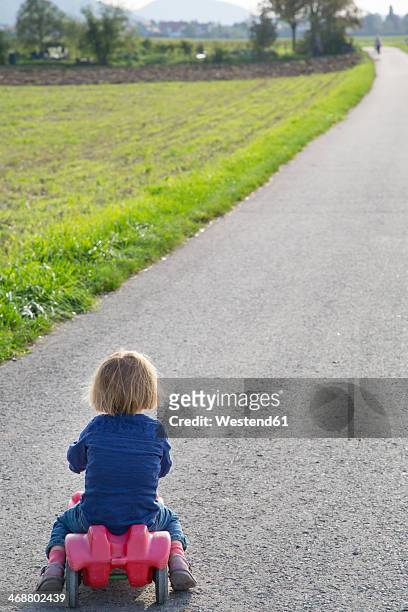 germany, baden-wuerttemberg, little girl on his bobby car - bobbycar stock pictures, royalty-free photos & images