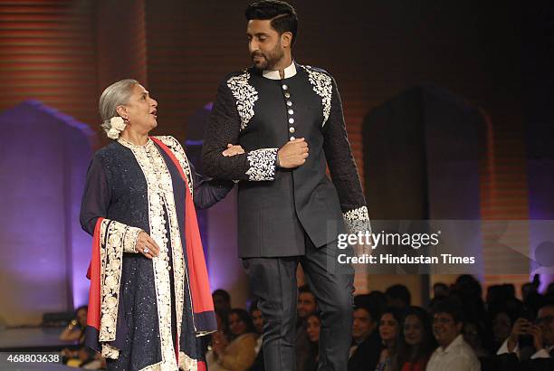 Bollywood actor Jaya Bachchan with her son and actor Abhishek Bachchan walk on the ramp during fund raising fashion show oraganized by NGO Mijwan at...