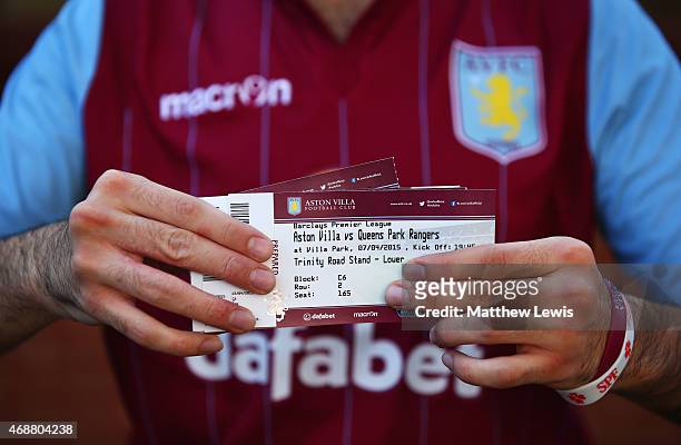 Fan shows his match ticket prior to the Barclays Premier League match between Aston Villa and Queens Park Rangers at Villa Park on April 7, 2015 in...