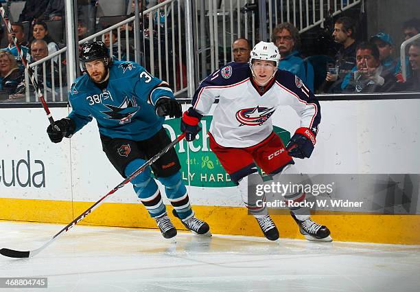Matt Calvert of the Columbus Blue Jackets skates against Bracken Kearns of the San Jose Sharks at SAP Center on February 7, 2014 in San Jose,...