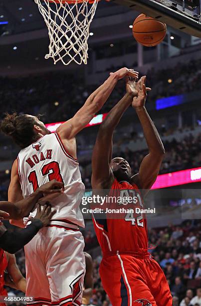 Joakim Noah of the Chicago Bulls blocks a shot by Elton Brand of the Atlanta Hawks at the United Center on February 11, 2014 in Chicago, Illinois....