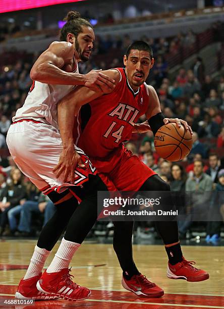 Gustavo Ayon of the Atlanta Hawks moves against Joakim Noah of the Chicago Bulls at the United Center on February 11, 2014 in Chicago, Illinois. NOTE...