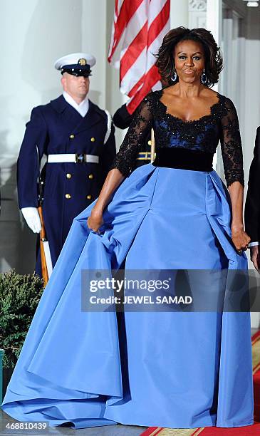 First Lady Michelle Obama arrives with US President Barack Obama to welcome French President Francois Hollande for a state dinner at the White House...