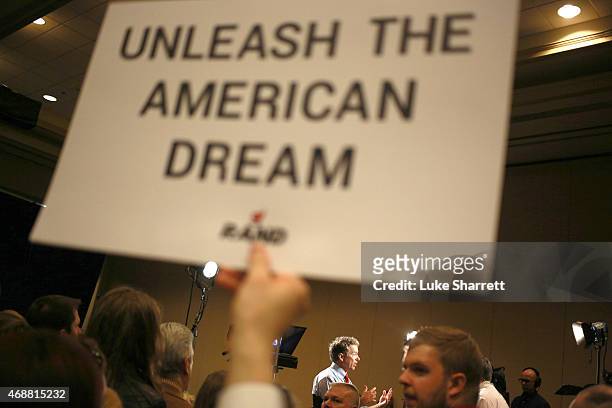 Supporter holds a sign as Sen. Rand Paul sits for an interview with Fox News after announcing his candidacy for the 2016 Republican presidential...