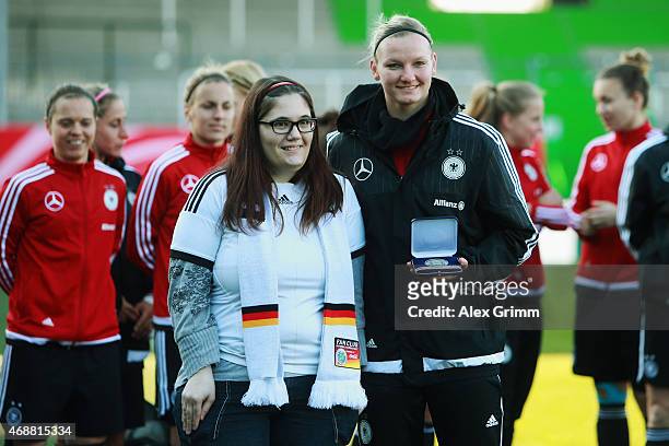 Alexandra Popp is honoured for scoring the best national team goal in 2014 during a Germany training session ahead of their friendly match against...