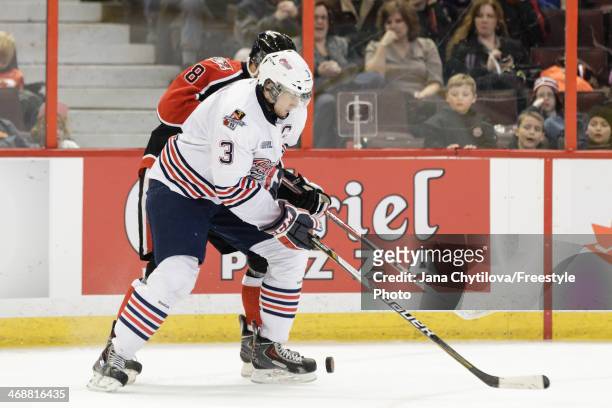 Ryan Van Stralen of the Ottawa 67's battles for the puck Josh Brown of the Oshawa Generals during an OHL game at Canadian Tire Centre on February 1,...