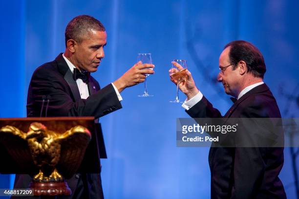 President Barack Obama and President Francois Hollande of France toast each other at the beginning of the State Dinner in Hollande's honor on...