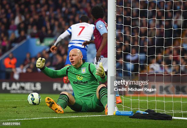 Goalkeeper Brad Guzan of Aston Villa reacts as Matt Phillips of QPR scores their first goal during the Barclays Premier League match between Aston...