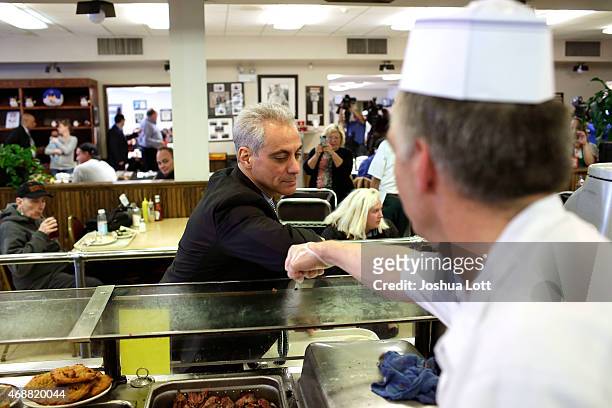 Chicago's mayor and candidate for re-election Rahm Emanuel greets a line-cook after placing his order for lunch at Manny's Deli April 7, 2015 in...