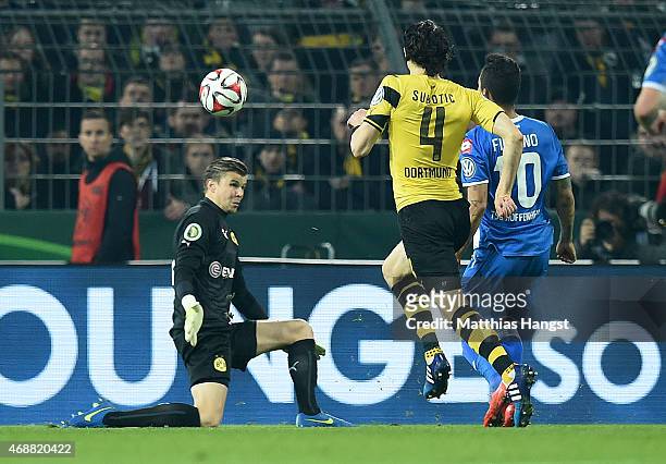 Roberto Firmino of Hoffenheim scores his team's second goal past goalkeeper Mitchell Langerak of Dortmund during the DFB Cup Quarter Final match...