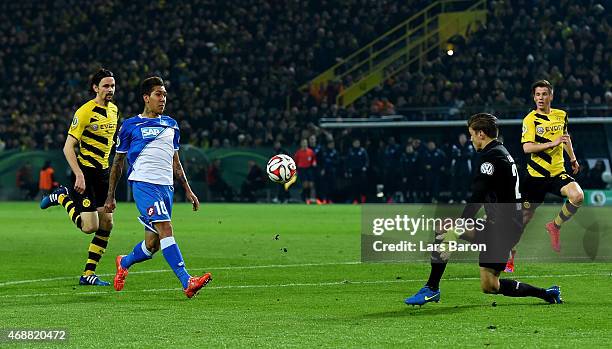 Roberto Firmino of 1899 Hoffenheim scores his teams second goal past goalkeeper Mitchell Langerak of Borussia Dortmund during the DFB Cup Quarter...