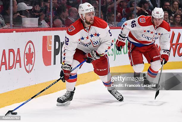 Mike Green of the Washington Capitals looks to pass the puck against the Montreal Canadiens in the NHL game at the Bell Centre on April 2, 2015 in...