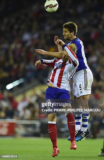 Atletico Madrid's forward Fernando Torres vies with Real Sociedad's midfielder Markel Bergara during the Spanish league football match Club Atletico...