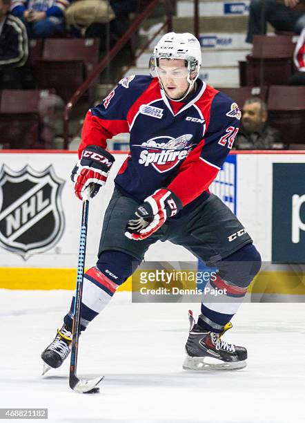 Defenceman Graeme Brown of the Windsor Spitfires moves the puck against the Guelph Storm on March 12, 2015 at the WFCU Centre in Windsor, Ontario,...