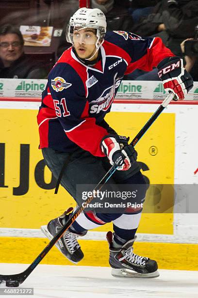 Defenceman Jalen Chatfield of the Windsor Spitfires moves the puck against the Guelph Storm on March 12, 2015 at the WFCU Centre in Windsor, Ontario,...