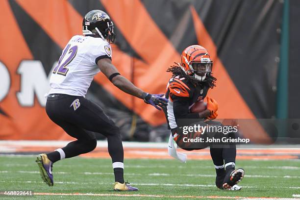 Dre Kirkpatrick of the Cincinnati Bengals runs the football upfield against Jacoby Jones of the Baltimore Ravens during a game at Paul Brown Stadium...