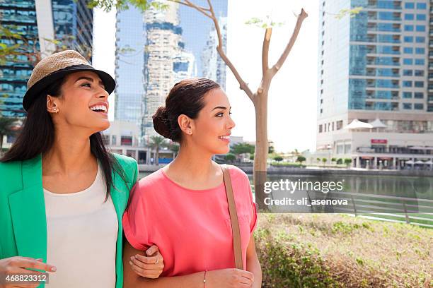 two girlfriends in dubai jumeirah lake towers - jumeirah stock pictures, royalty-free photos & images