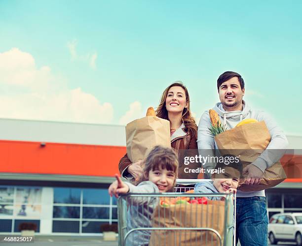 family after shopping on parking lot. - white shopping bag bildbanksfoton och bilder