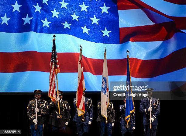 The DC National Color Guard Joint Color Guard stands on stage during the Maya Angelou Forever Stamp Dedication at Warner Theatre on April 7, 2015 in...