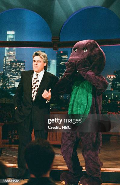 Episode 952 -- Pictured: Host Jay Leno and Barney during the monologue on June 26, 1996 --