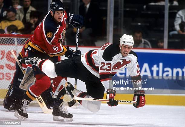 Dave Andreychuk of the New Jersey Devils looks to be tripped up by Gord Murphy of the Florida Panthers circa 1999 at the Continental Airlines Arena...