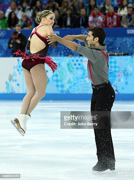 Rudi Swiegers and Paige Lawrence of Canada compete during the Figure Skating Pairs Short Program on day 4 of the Sochi 2014 Winter Olympics at...