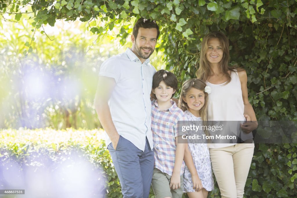 Family smiling under ivy