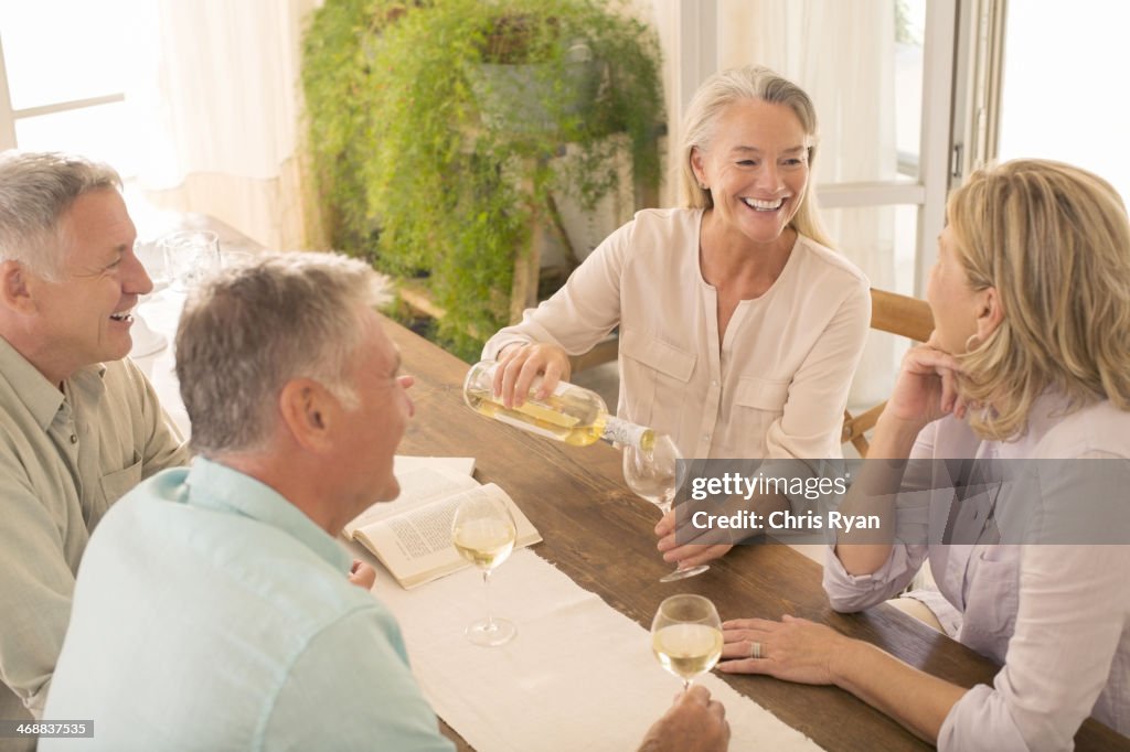 Senior couples drinking wine at dining table