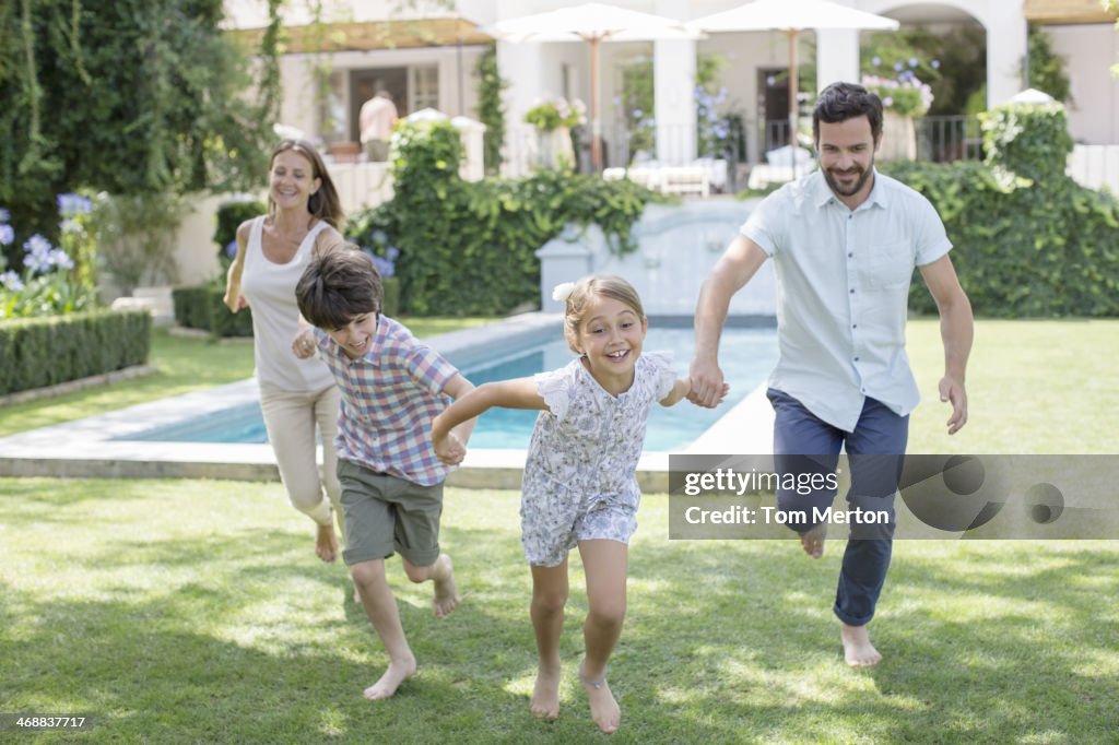 Family running together in backyard