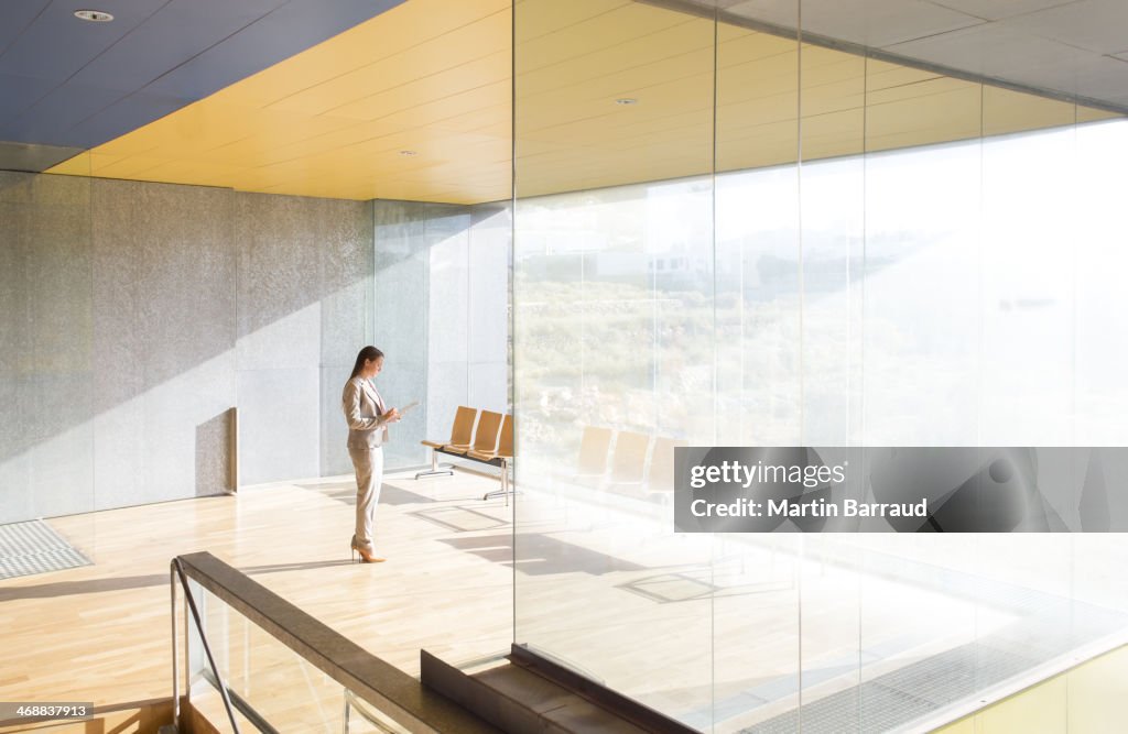 Businesswoman standing in sunny office