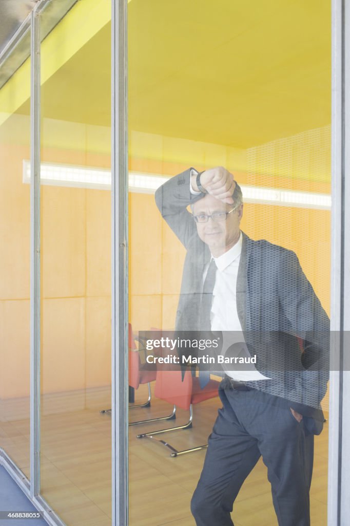 Businessman standing at office window